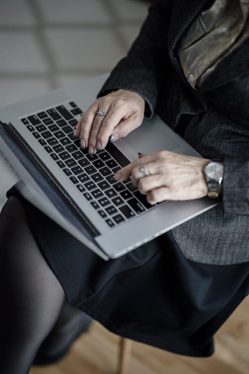 Hands on laptop building a ChatGPT traffic in GA4 exploration with source and medium filters